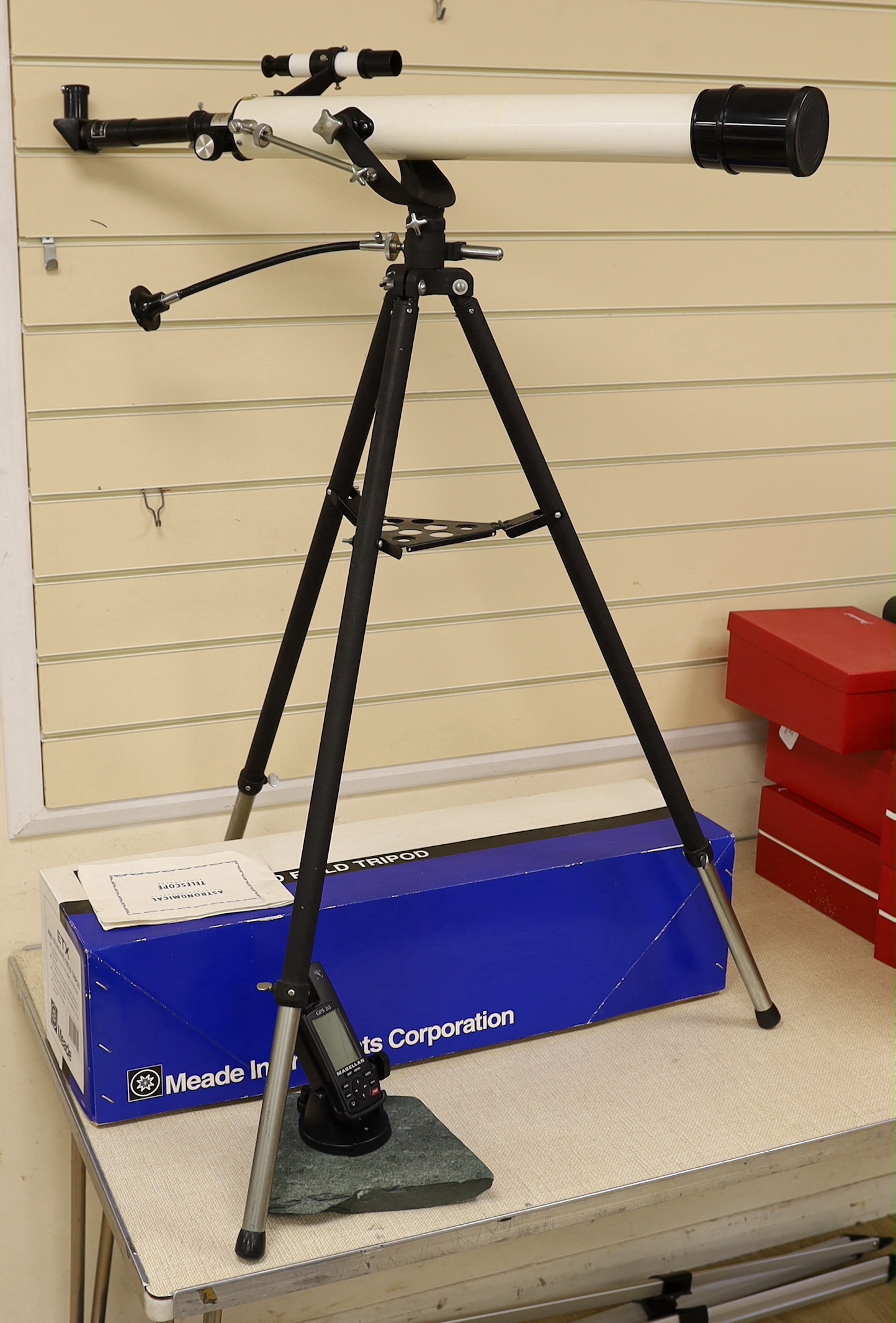 A telescope on tripod stand and a Meade scope and tripod, telescope and stand 105cm high